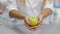 Pharmacist holding an apple