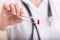 Pharmacist holding tweezers with pill