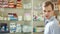 Pharmacist woman offers the visitor a cure at the chemists shop