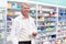 Pharmacist at work. Portrait of mature pharmacist holding a prescription in drugstore.