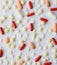 Pharmacology assorted medicine pills, tablets and capsules background pattern texture. Different colors tablet on white