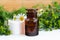 Pharmacy bottle with cosmetic/cleansing/healing wild chamomile aroma oil or tincture and cotton pads for natural skin care