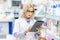 Pharmacy details - doctor in white uniform using tablet and technology in pharmaceutical or medical field