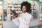 Pharmacy and healthcare concept, inventory. Young attractive smiling African American woman pharmacist or chemist