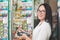 Pharmacy and the seller. A woman in glasses with a smile makes a purchase on a Bank card using a mobile terminal