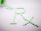 Pharmacy symbol, Rx word made by light green tablets isolated on