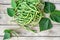 Phaseolus vulgaris green common beans on wooden table with leaves