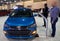 Philadelphia, Pennsylvania, U.S.A - February 9, 2020 - A man inspecting the blue color of the 2020 Chevy Bolt all electric vehicle