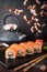 Philadelphia roll sushi with salmon, cucumber, avocado, cream cheese, tobiko caviar. Sushi menu.