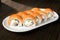 Philadelphia roll sushi with salmon, smoked eel, avocado, cream cheese. Sushi menu. Japanese food.