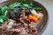 Philippine, Taiwanese or Chinese authentic traditional dish: beef noodle soup with vegetables, closeup