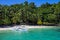 Philippine wooden boat and white beach on sunny day. Tropical island paradise photo. Palm tree jungle forest