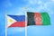 Philippines and Afghanistan two flags on flagpoles and blue cloudy sky