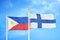 Philippines and Finland two flags on flagpoles and blue cloudy sky