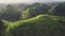Philippines hilly countryside aerial: misty haze over mountain ranges with tropical jungle forest