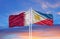 Philippines and Qatar two flags on flagpoles and blue cloudy sky.