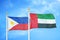 Philippines and United Arab Emirates two flags on flagpoles and blue cloudy sky