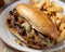 Philly cheesesteak sandwich and french fries