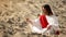 Philosopher pouring sand from hand in desert, reflecting on life and time