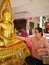 PHITSANULOK, THAILAND - OCT 31, 2018 : Buddhists make merit ,Gilding gold leaf to Buddha for worship. ,Buddhist culture for happy