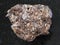 Phlogopite stone with corundum crystal on dark