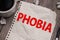 Phobia, text words typography written on paper against wooden background, life, psychology and mental health