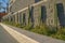 Phoenix, Arizona- Planter with plants and columnar cacti outside a building with stone block wall