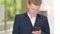 Phone. Business man using phone sms texting using app on smartphone in city business district. Young businessman using