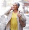 Phone call, communication and senior woman walk, travel or on urban city commute while talking to cellphone contact