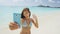 Phone girl using smartphone on beach waving hand saying hello hi on video chat