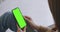 Phone with Green Screen and Chroma Key Closeup. Chromakey Mockup with Tracking Markers and Alpha Matte. POV is Vertical