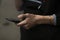 Phone in guys hand. Hand holds smartphone. Smartphone navigation details