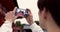 Phone, hands and tourist with picture in Japan on vacation, holiday trip or travel. Smartphone, person and closeup