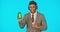 Phone, headphones and business man with green screen in studio isolated on blue background mockup. Face portrait, coffee