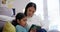 Phone, kid and mother support with a children and education online game on living room floor. Mom, young girl and mobile