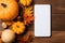 Phone mock up blank screen on Halloween Thanksgiving background.