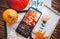 Phone and pictures in frame on brown wood background with pumpkins