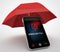 Phone and red umbrella protect concept