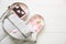 Phone, stylish bag and perfumes on white background. Beautiful flat lay with hearts. The best present for the girl. Woman`s or