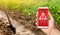 A phone and a warning sign on the background of pepper plantation and irrigation channel with a shovel. Harmful pesticides