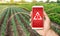 The phone warns of the danger on the farm field. Monitoring and analysis of presence of chemicals, heavy metals, pollution,