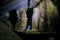 Phong Nha Ke national park / Vietnam, 16/11/2017: Woman with headlamp standing next to giant stalactites inside the Hang Tien cave