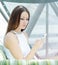 Phoning woman sitting relaxed at cafe