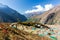 Phortse village houses green roofs above view, Nepal mountains.