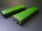 photo of 2 pieces of tempeh wrapped in green banana leaf with black background