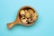 A photo from above of small uncooked quail eggs in wooden mug on the blue table. An overhead photo of quail eggs, Easter rustic ba