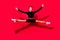 Photo of active energetic cheerful lady jump enjoy flight wear black cropped top isolated red color background