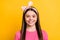 Photo of adorable charming school girl wear pink t-shirt smiling isolated yellow color background