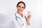 Photo of adorable cheerful young woman doctor wear formal coat tacking selfie smiling showing v-sign isolated white
