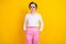 Photo of adorable cool age woman dressed white shirt dark glasses standing arms pockets smiling isolated yellow color